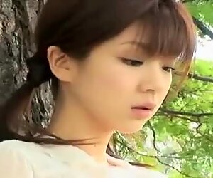 Elegant Japanese angel Aki Hoshino eats ice cream in the park